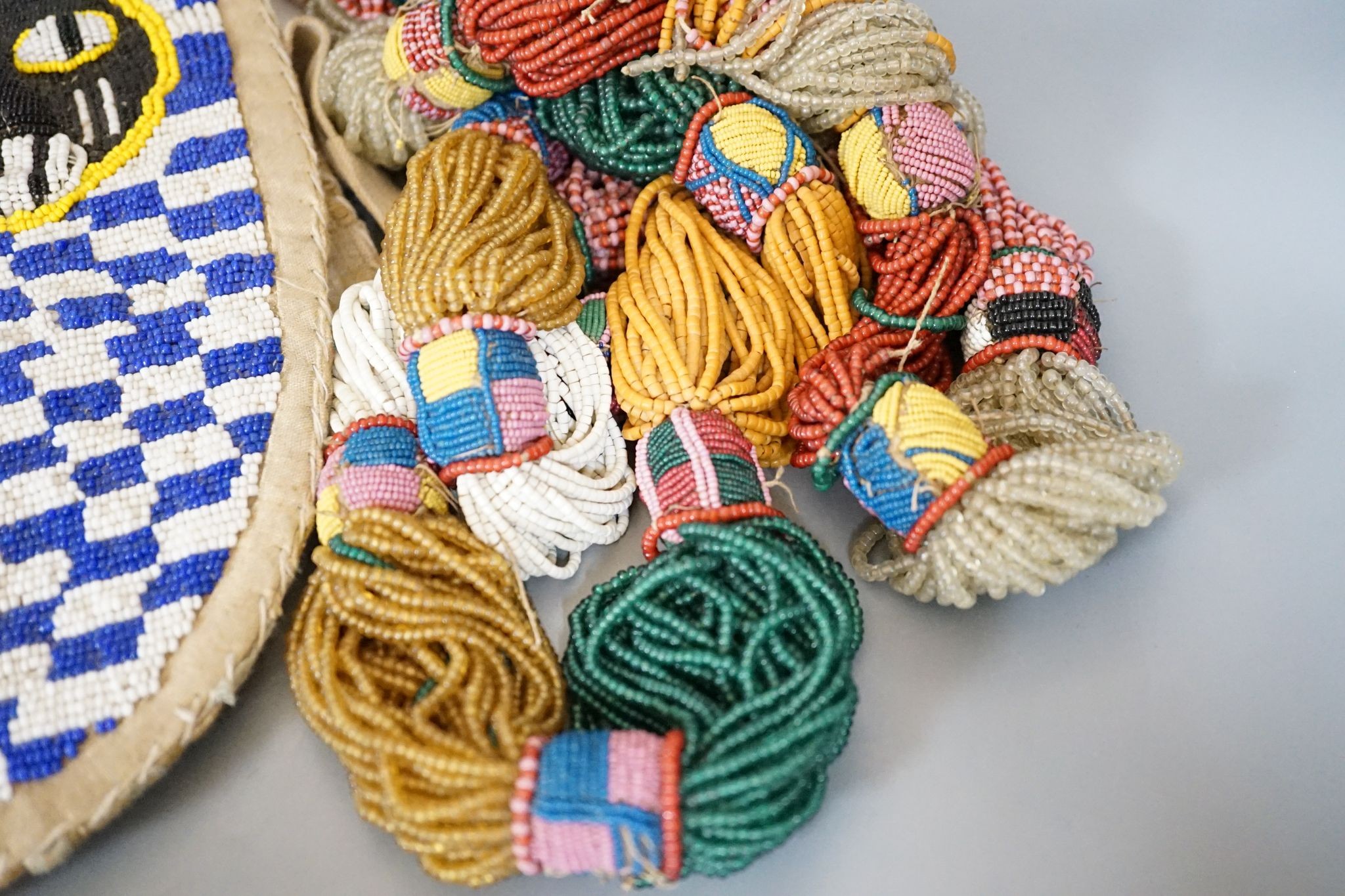 A large African beadwork necklace and three beadwork bags